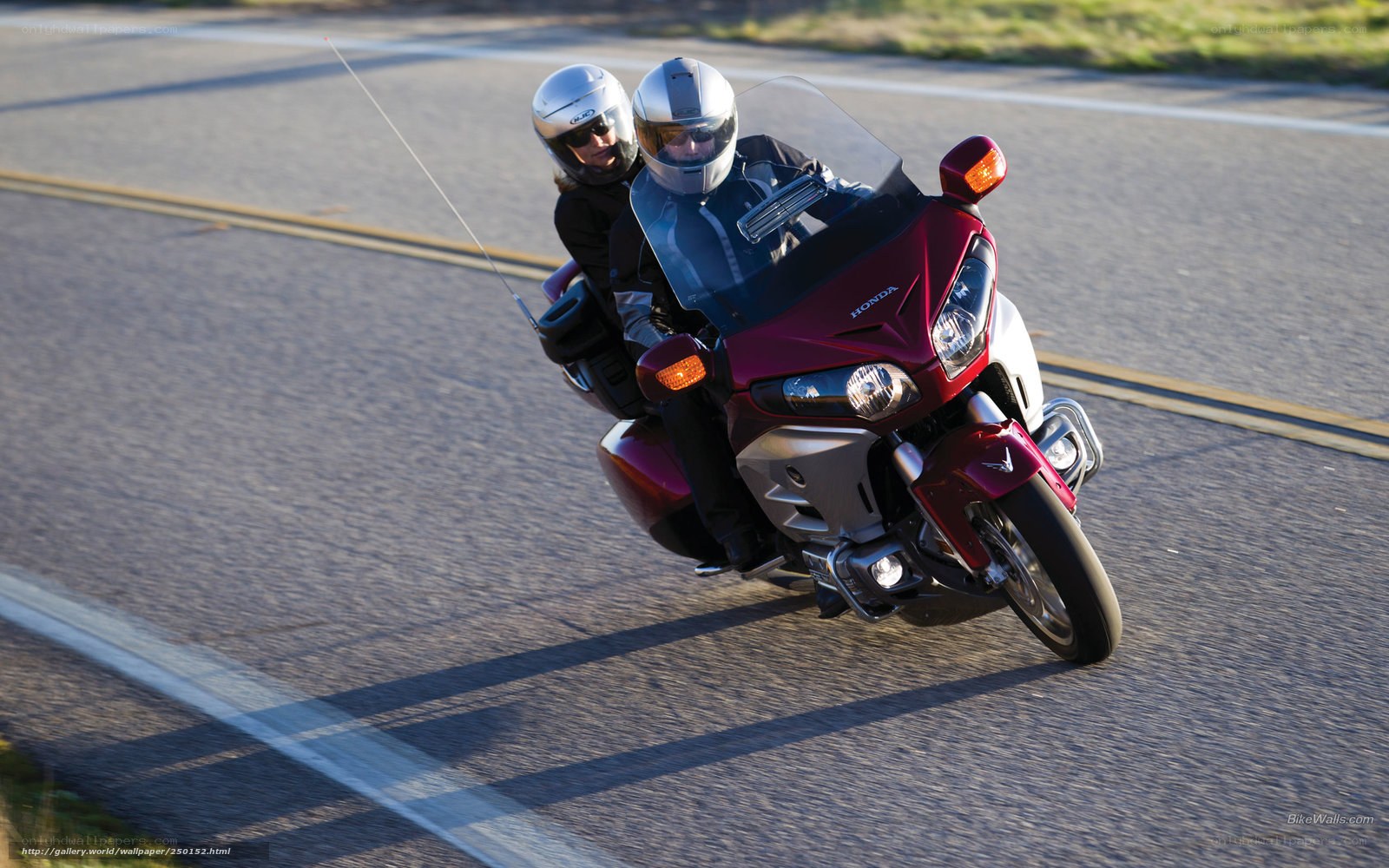 Couple riding red motorcycle