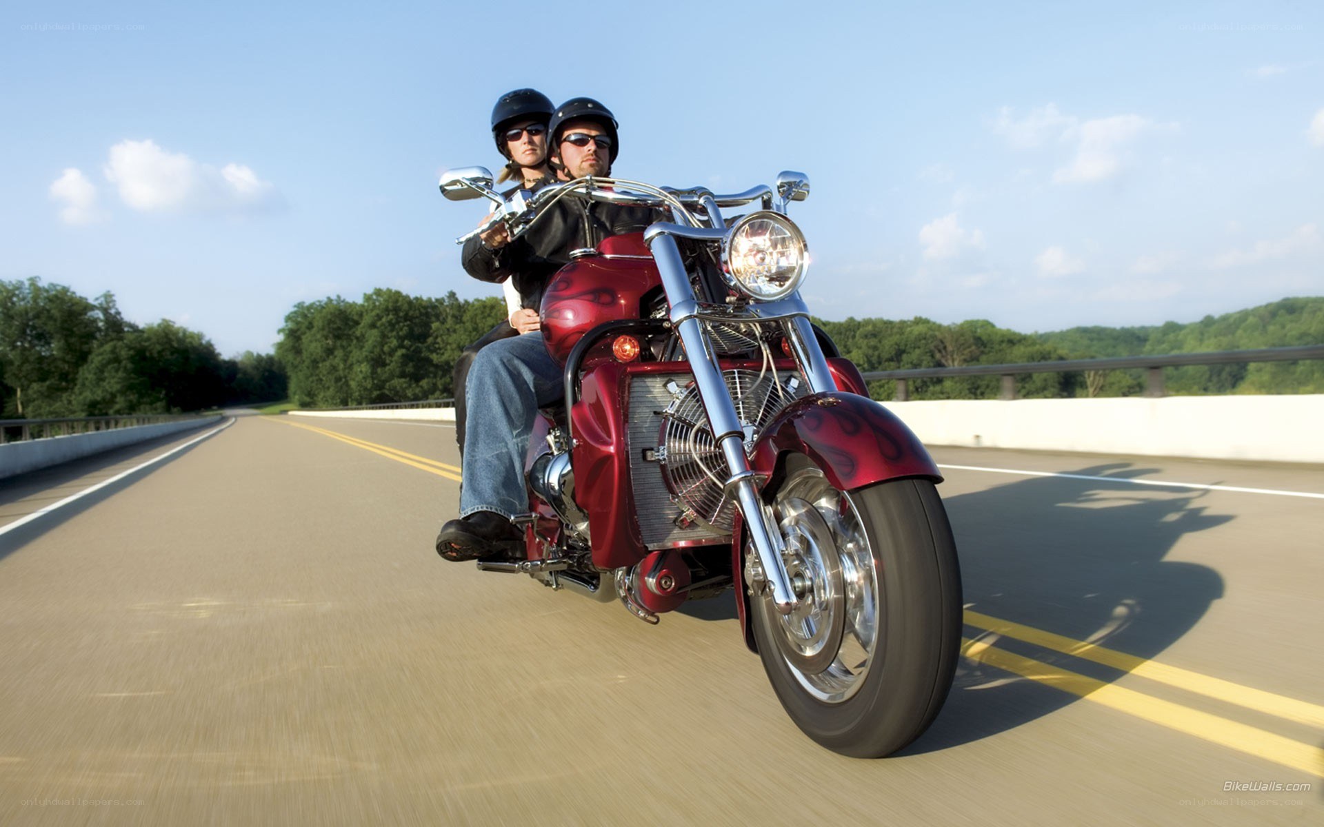 Couple riding red motorcycle