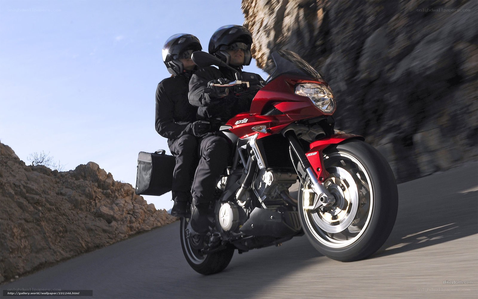 Couple riding red motorcycle