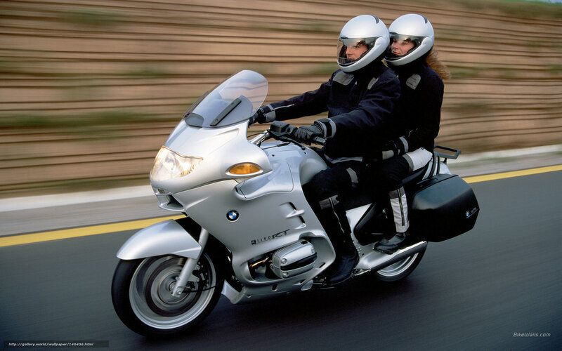 Couple riding silver motorcycle