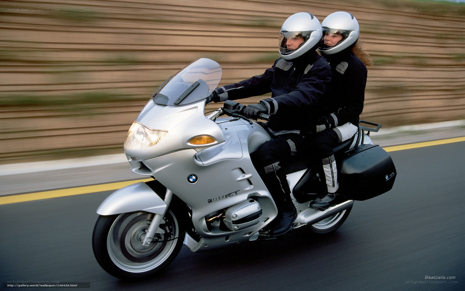 Couple riding silver motorcycle