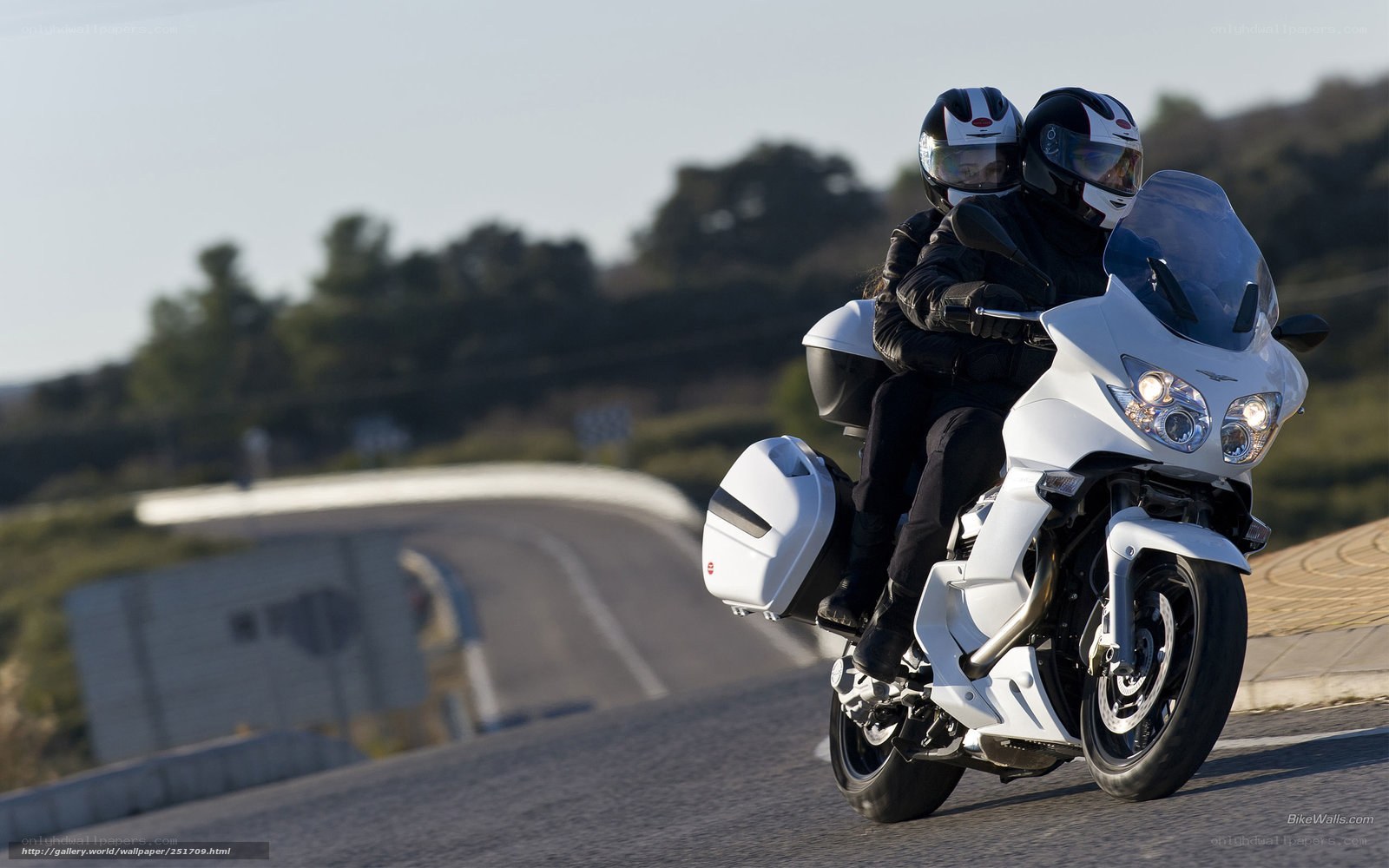 Couple riding white motorcycle
