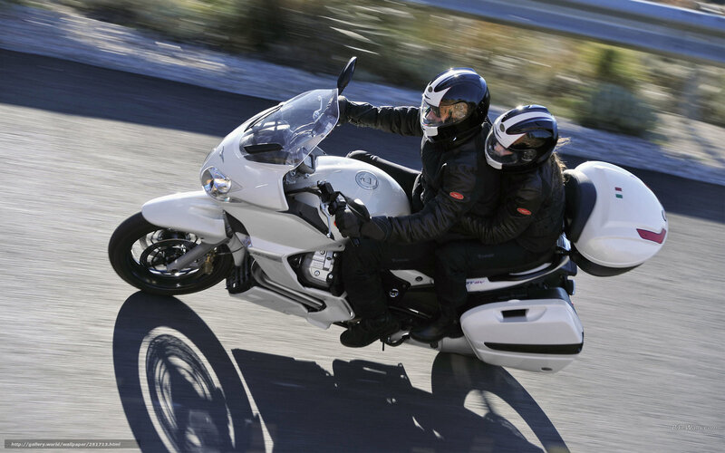 Couple riding white motorcycle