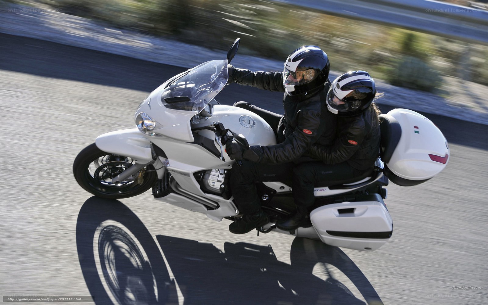 Couple riding white motorcycle
