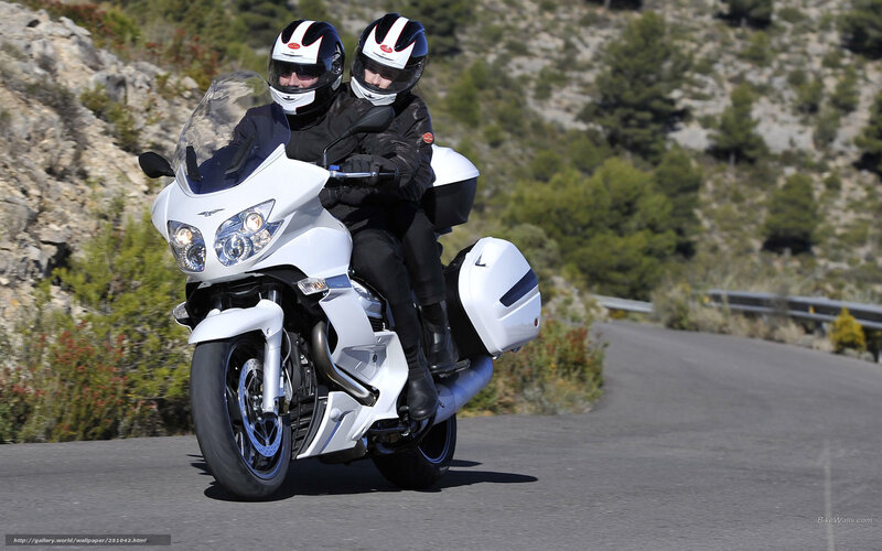 Couple riding white motorcycle