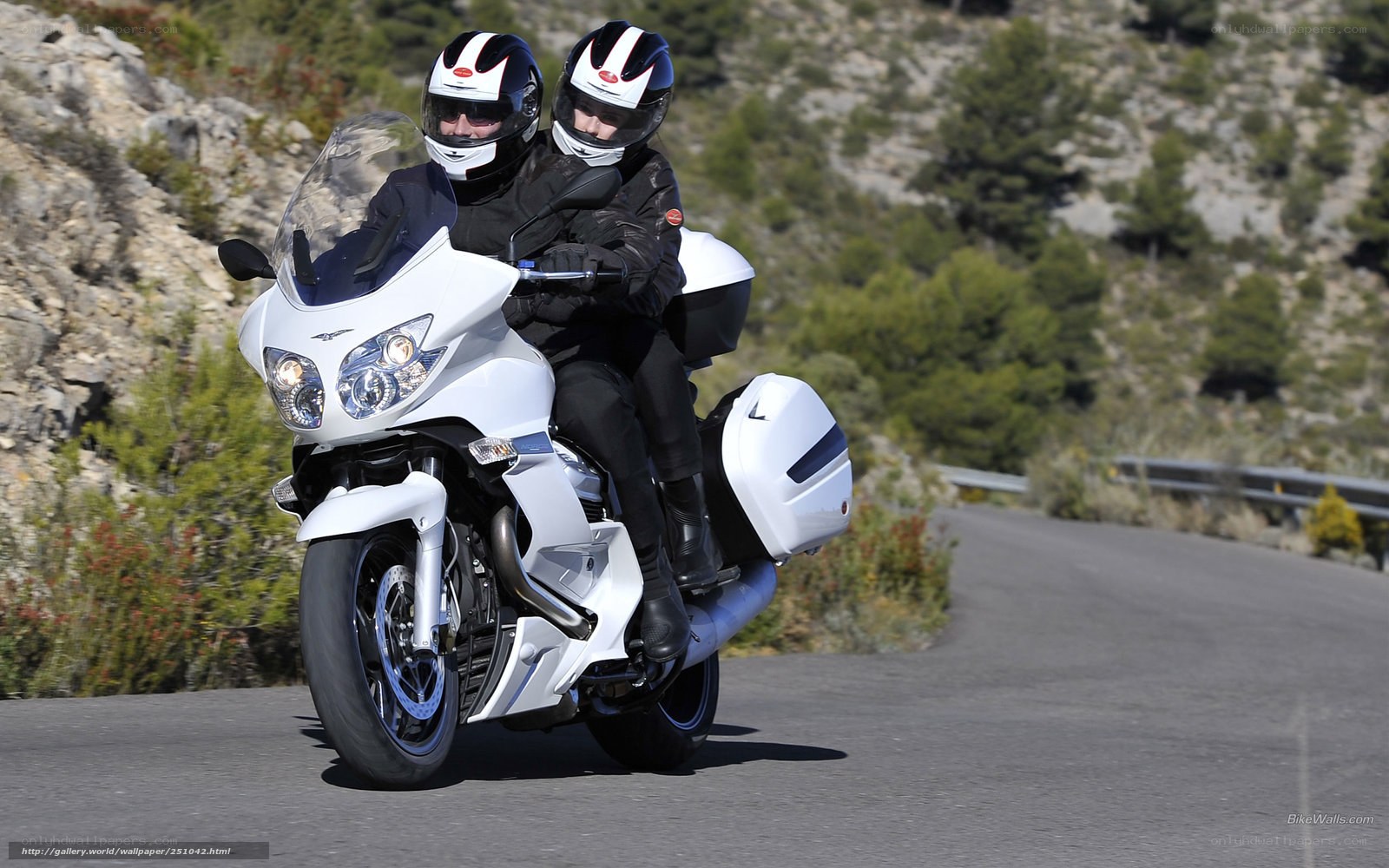 Couple riding white motorcycle