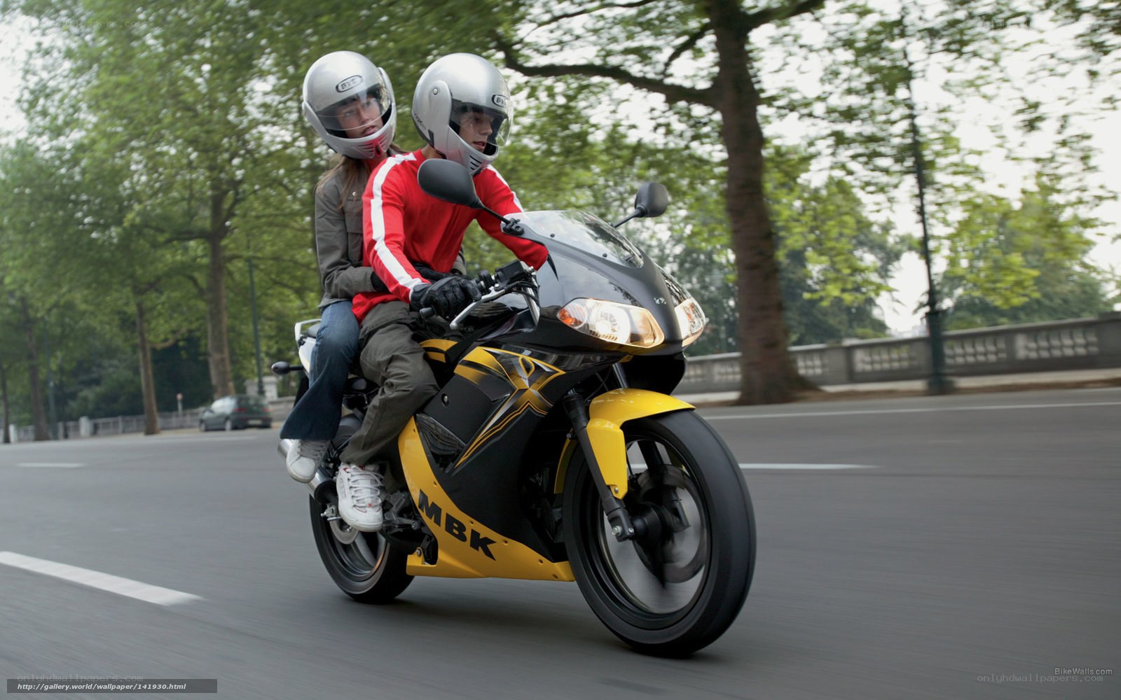 Couple riding yellow motorcycle