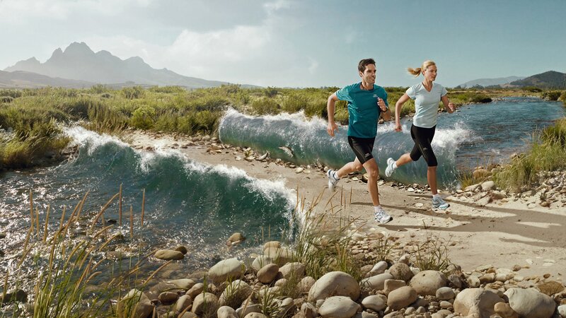 Couple running by river