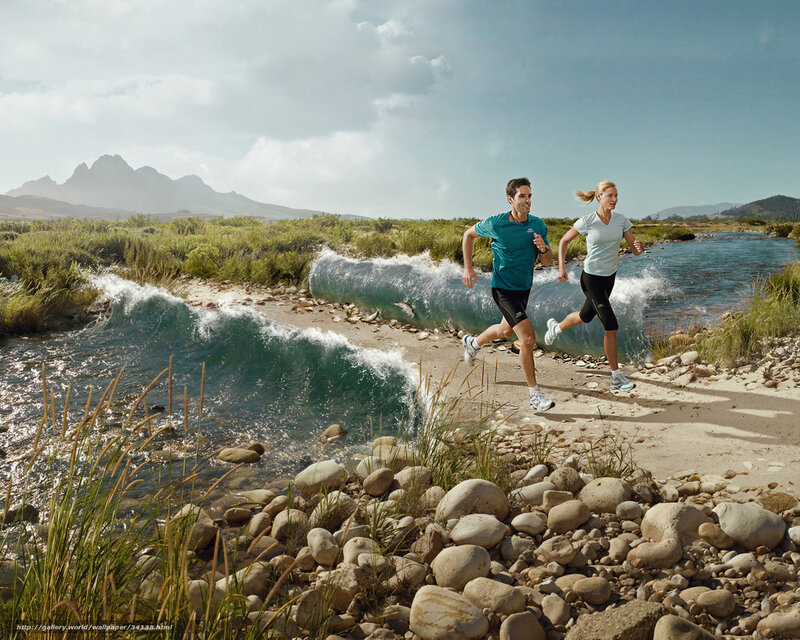 Couple running by river