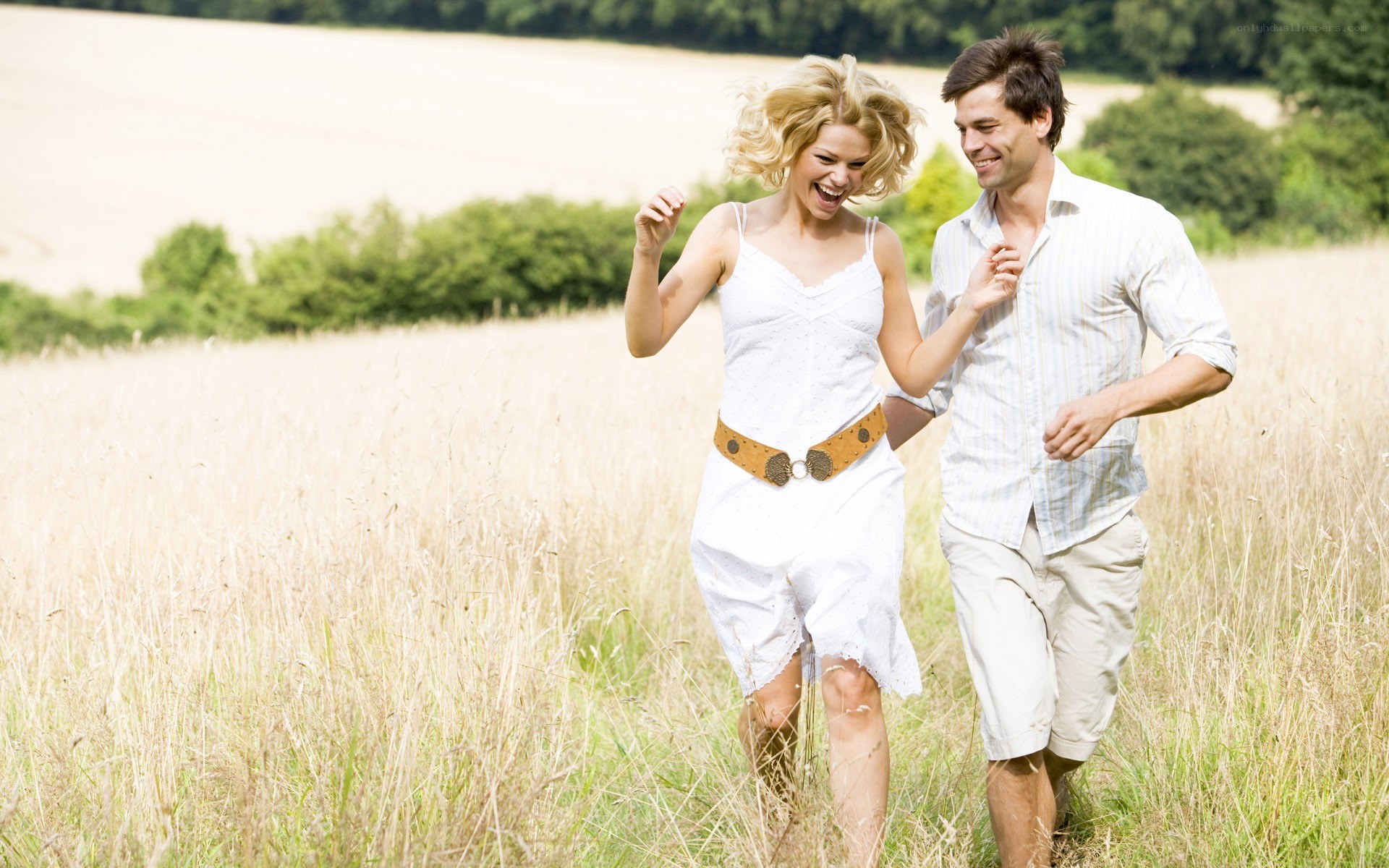 Couple running in a field