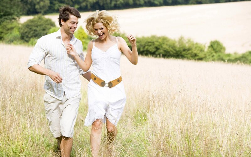 Couple Running in Field