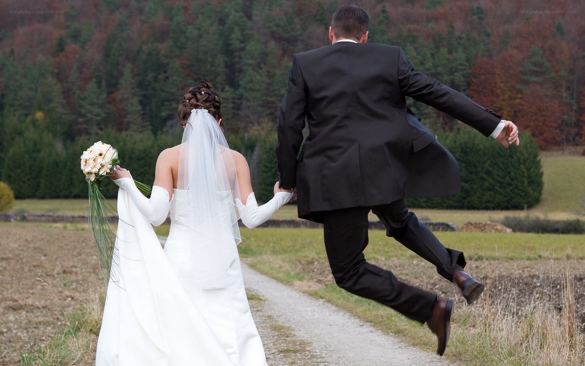Couple running on wedding day