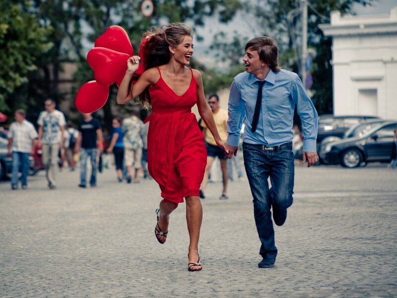 Couple running with balloons