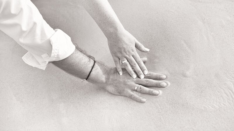 Couple's Hands on Sand