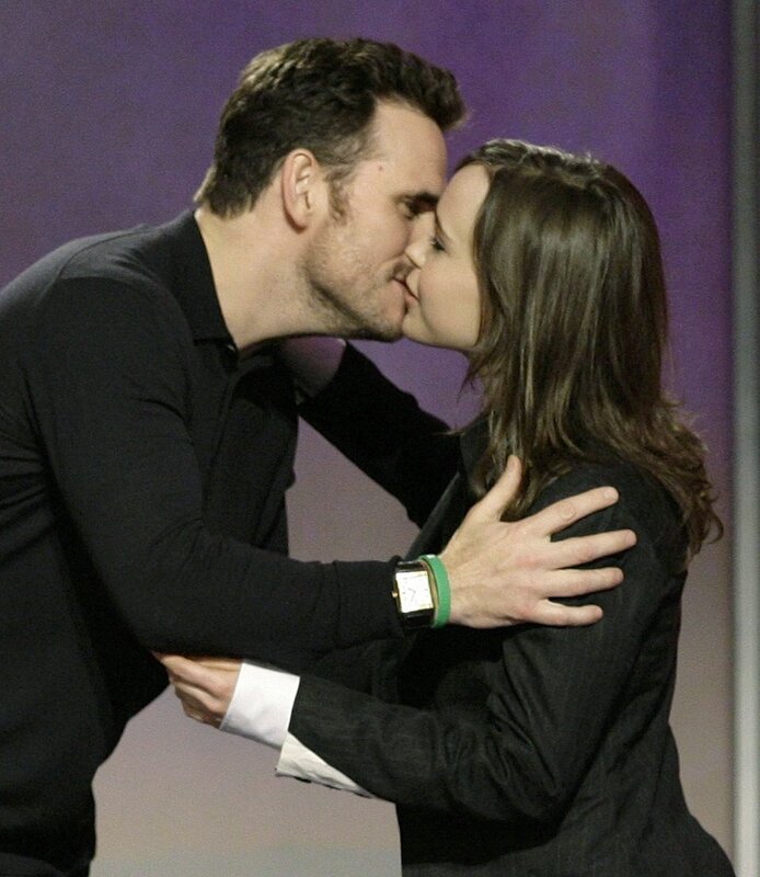 couple sharing a kiss on stage