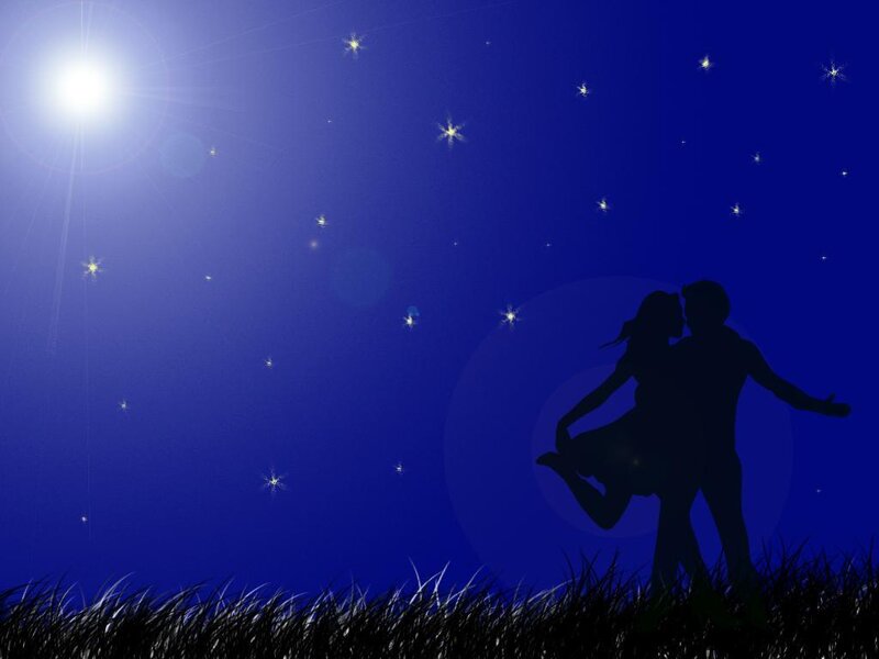 Couple silhouette under starry sky