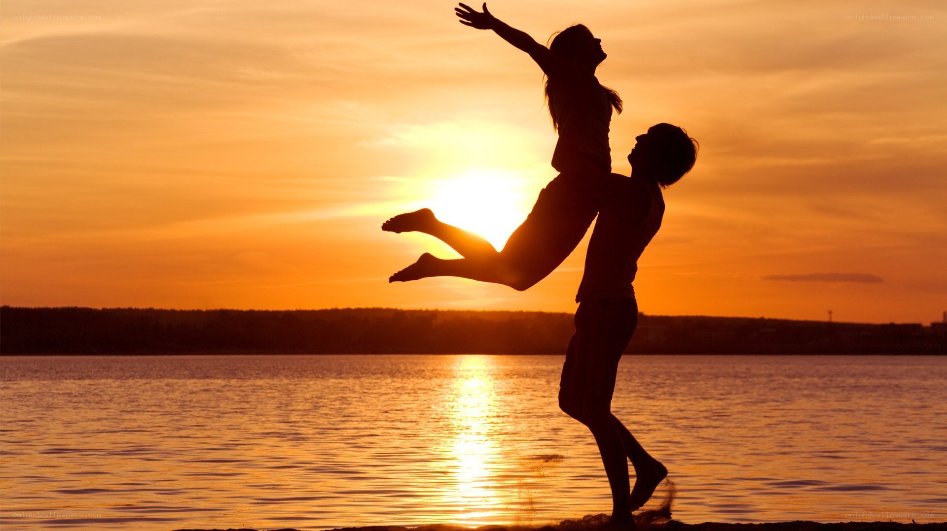 Couple silhouetted at sunset