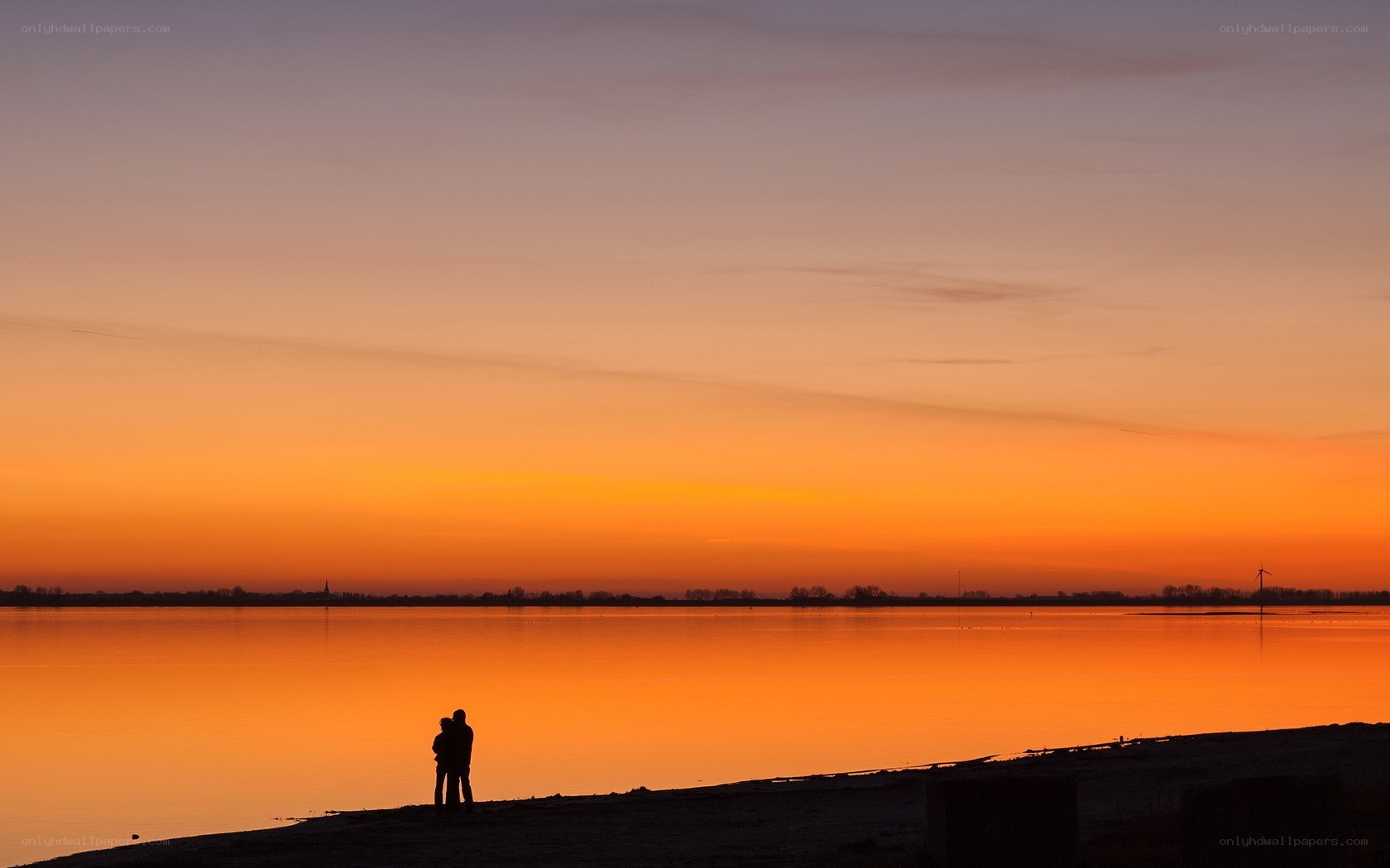 Couple silhouetted at sunset