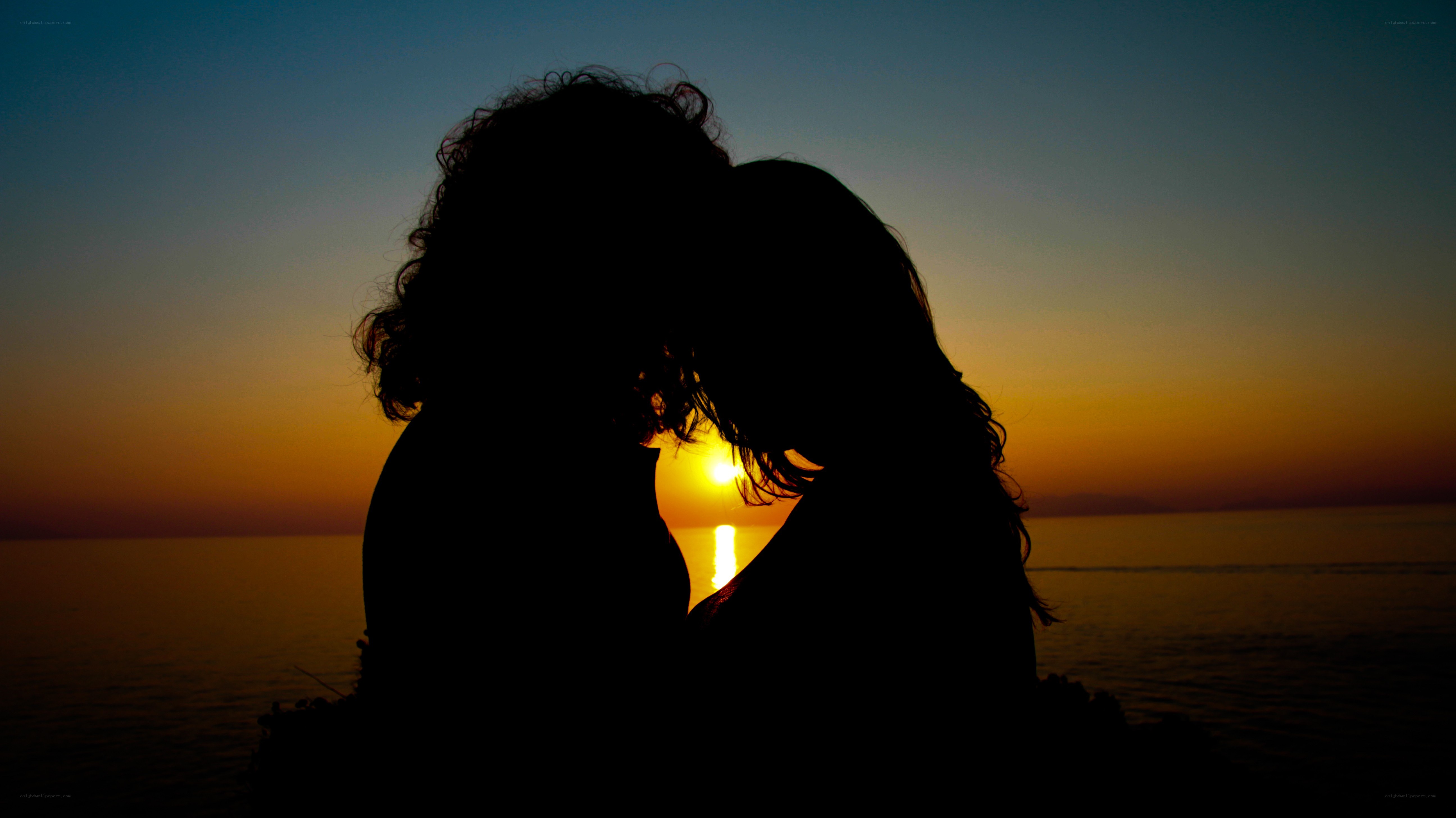 Couple silhouetted at sunset