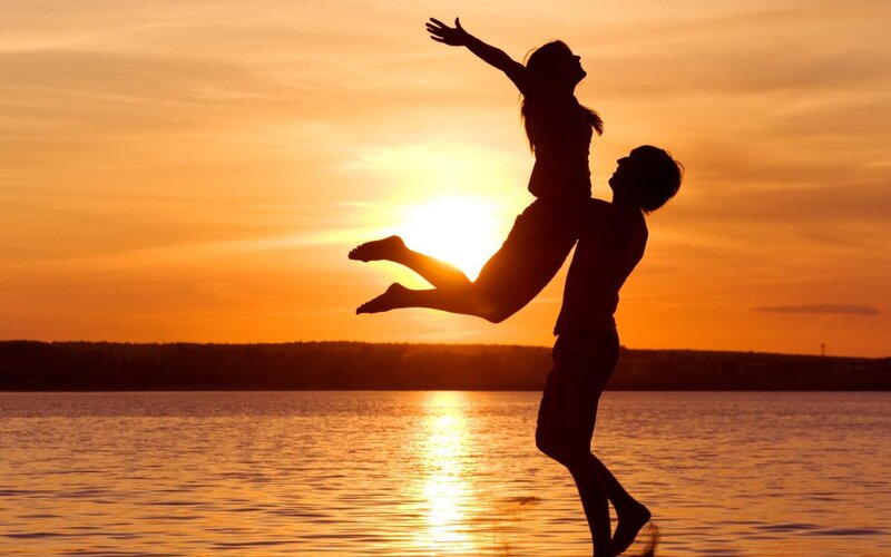 Couple silhouetted at sunset