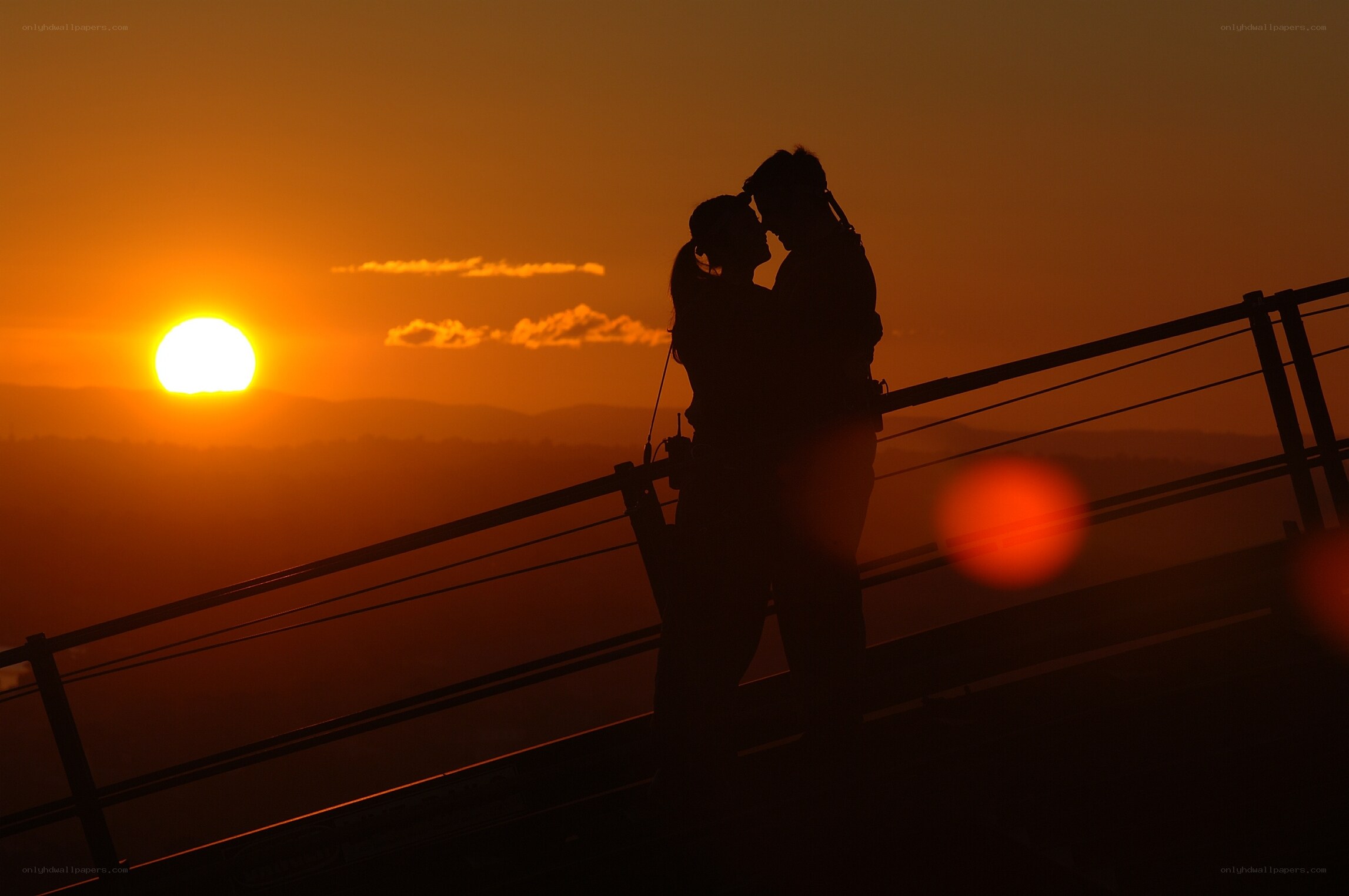 Couple silhouetted at sunset
