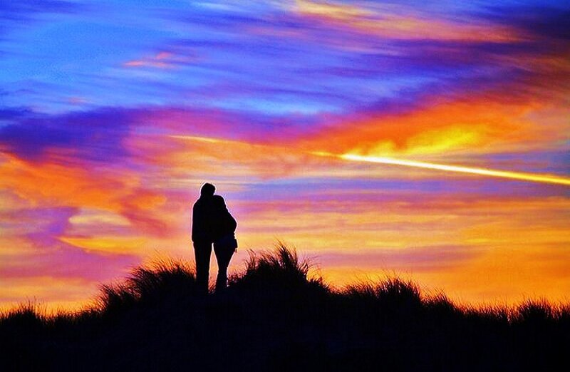 Couple silhouetted at sunset