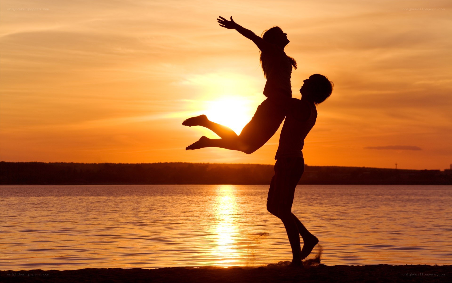 Couple silhouetted at sunset