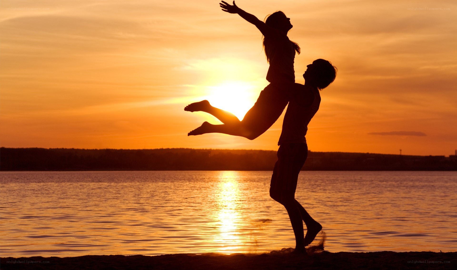 Couple silhouetted at sunset