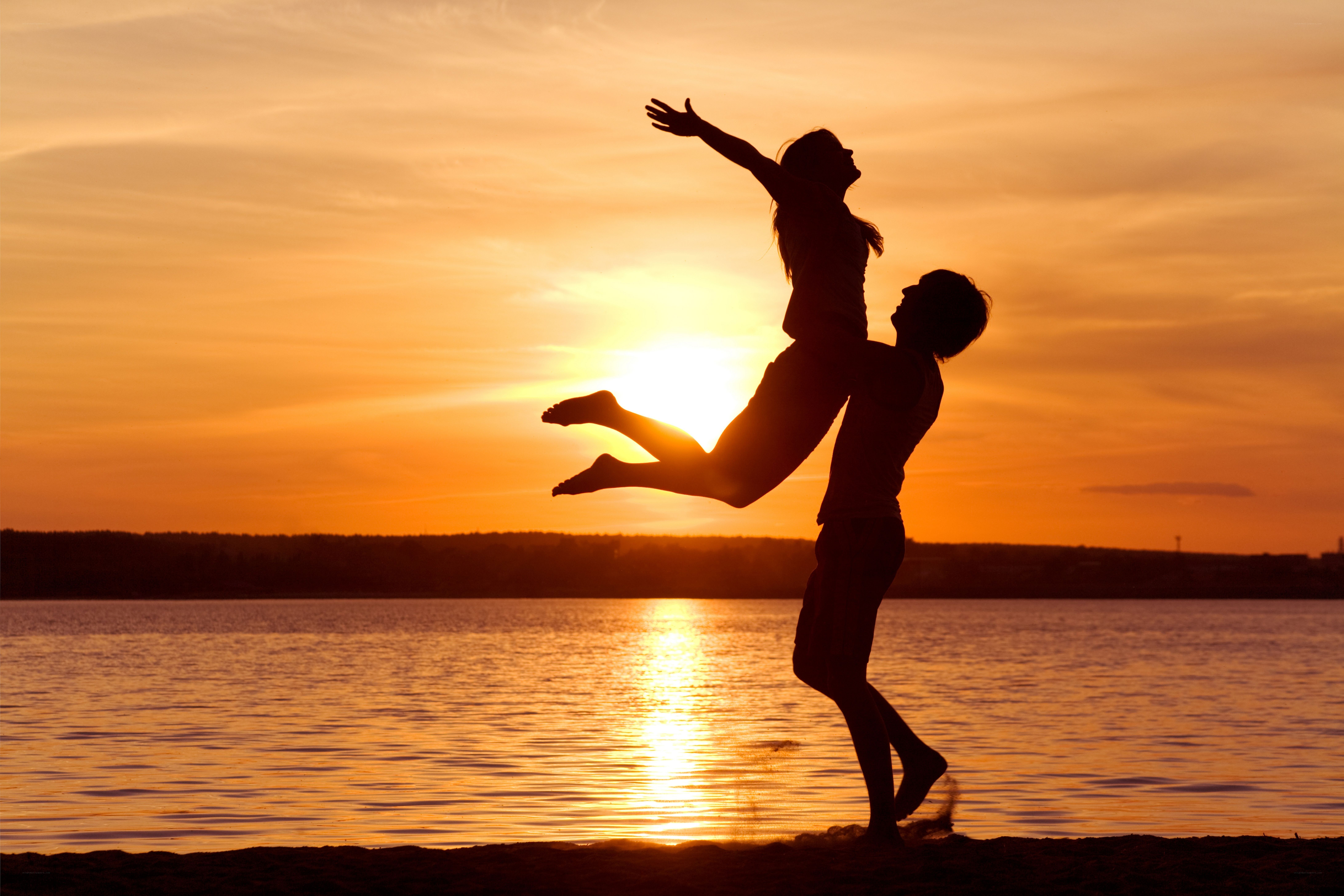 Couple silhouetted at sunset