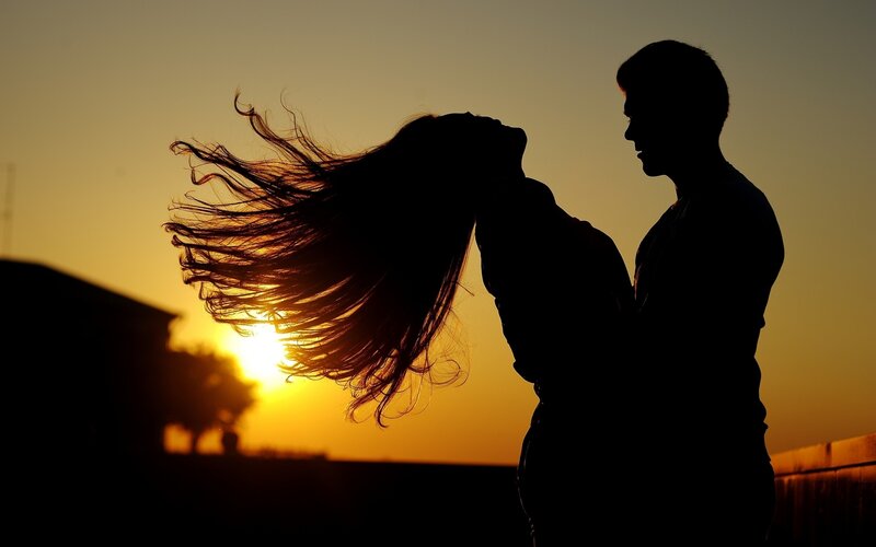 Couple Silhouetted at Sunset — Orange, Dramatic, Photograph, Hair