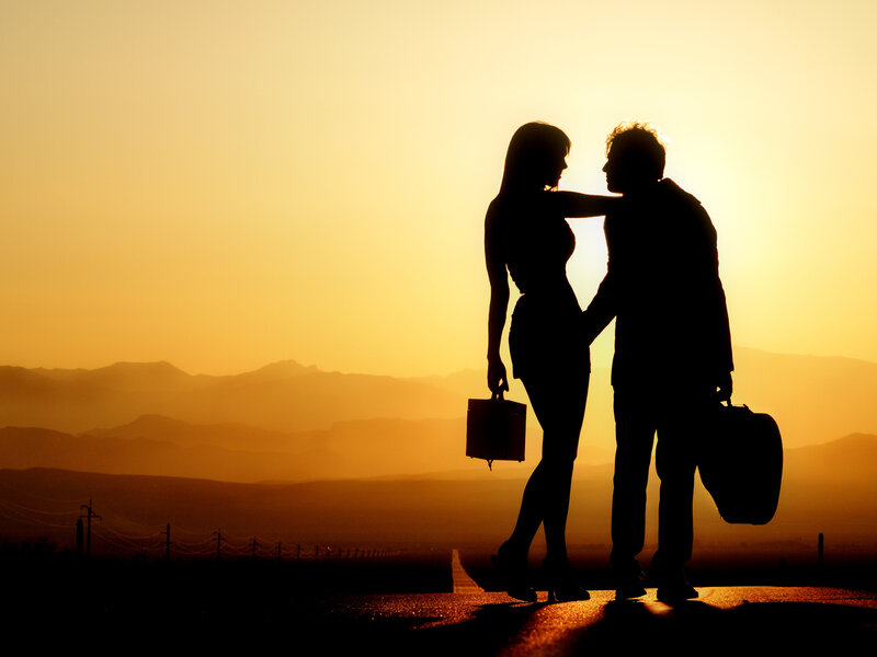 Couple Silhouetted at Sunset — Orange, Dramatic, Photograph, Mountains