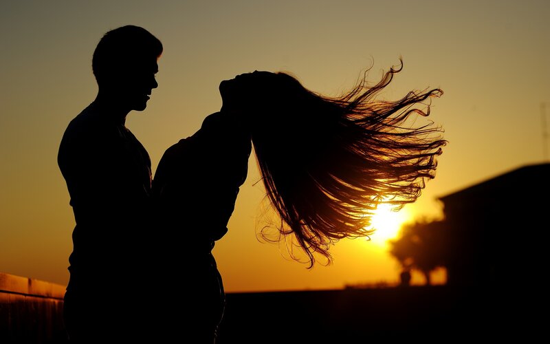 Couple Silhouetted at Sunset — Orange, Dramatic, Photograph, Sun