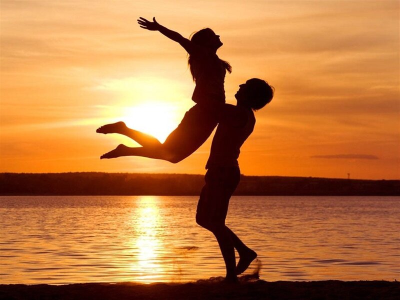 Couple Silhouetted at Sunset — Orange, Dramatic, Photograph, Water