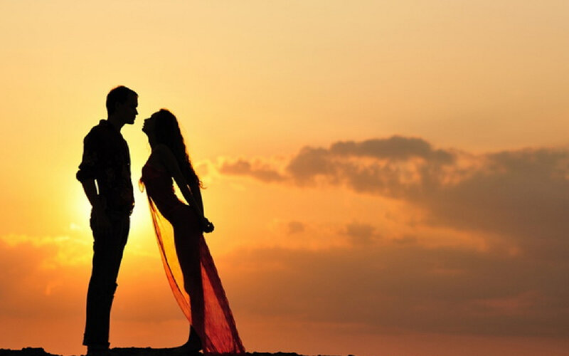 Couple Silhouetted at Sunset — Orange, Romantic, Photograph