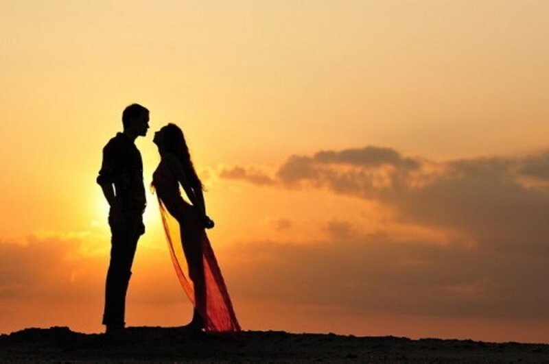 Couple Silhouetted at Sunset — Orange, Romantic