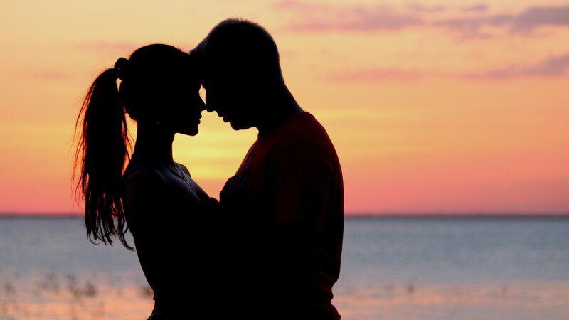 Couple Silhouetted at Sunset — Orange, Serene, Photograph, Silhouette
