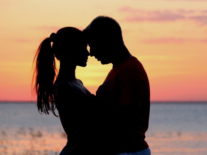 Couple Silhouetted at Sunset — Orange, Serene