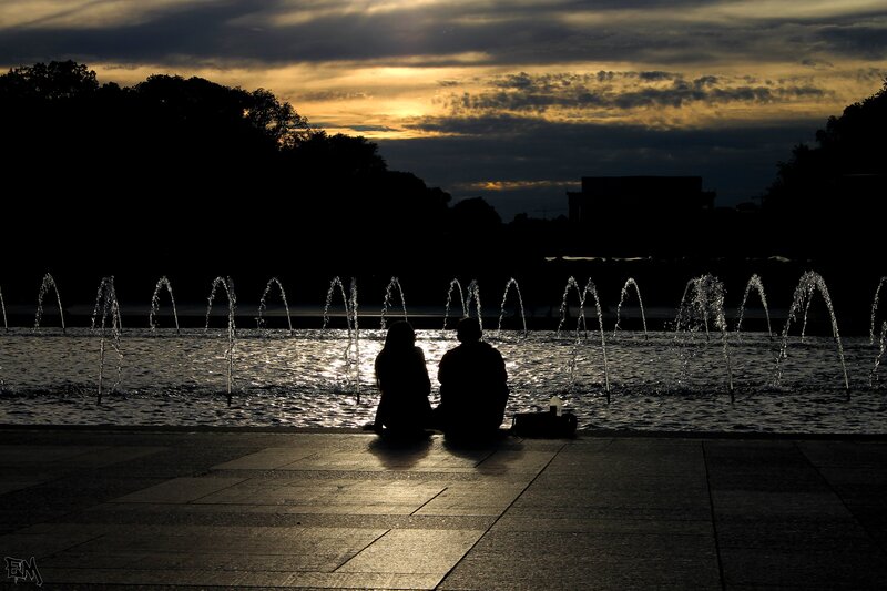 Couple Sitting by Fountain — Black