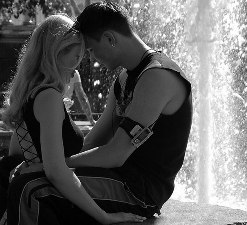 couple sitting by fountain