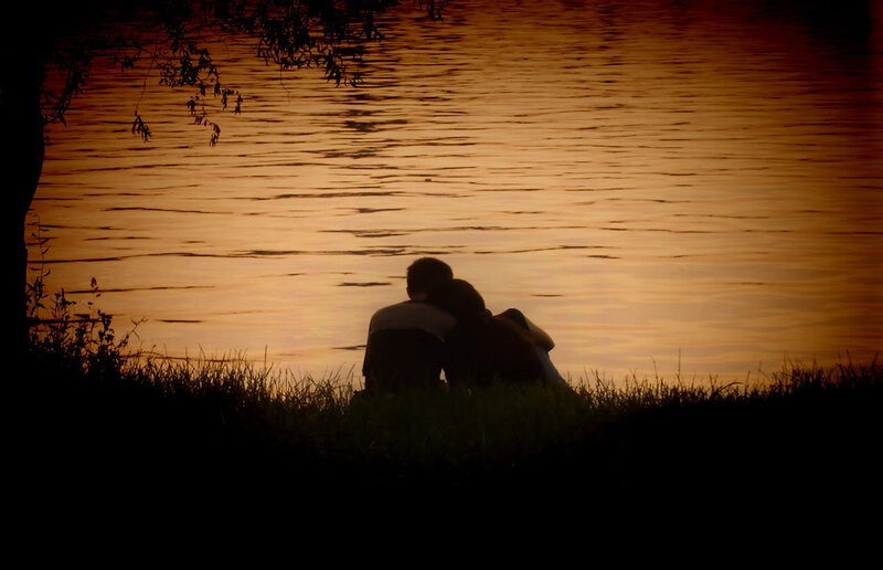 Couple Sitting by Water — Orange, Serene