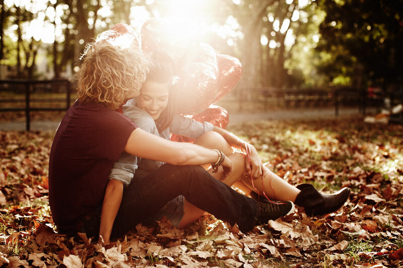 Couple Sitting in Leaves