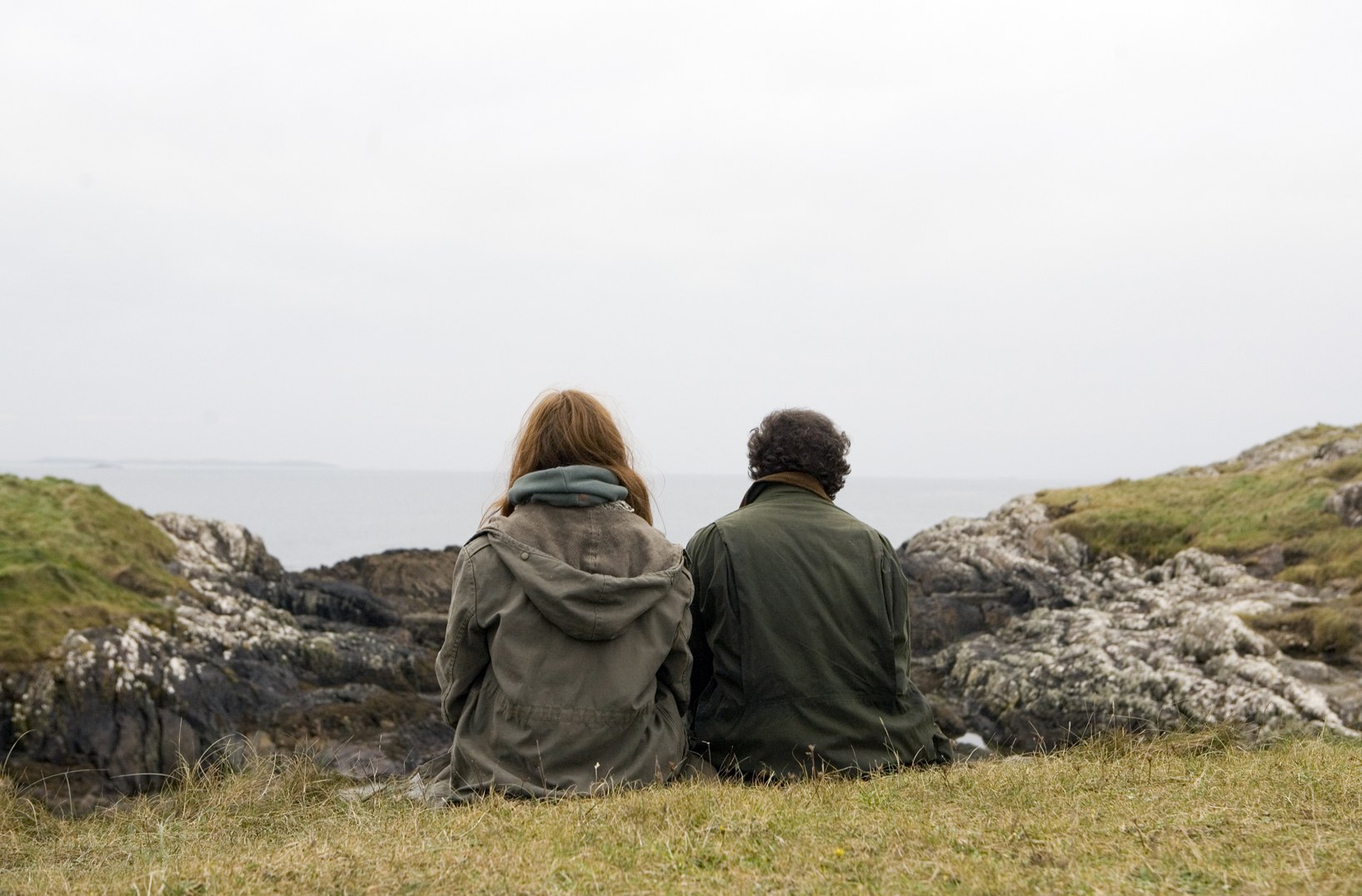 Couple sitting on a cliff