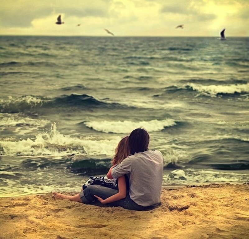 Couple Sitting on Beach — Blue, Serene