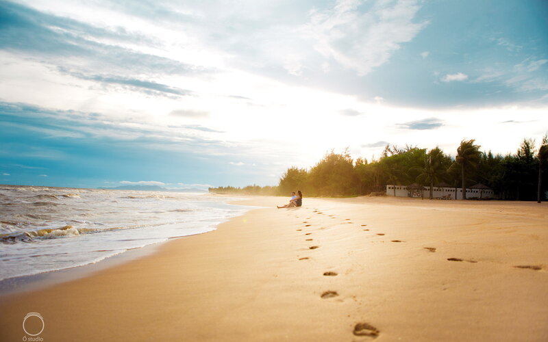 Couple Sitting on Beach — Blue