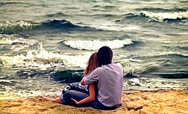 Couple Sitting on Beach — Brown