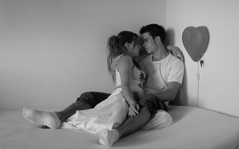 Couple Sitting on Bed