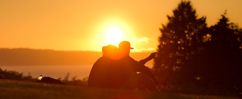 Couple Sitting on Grass — Orange