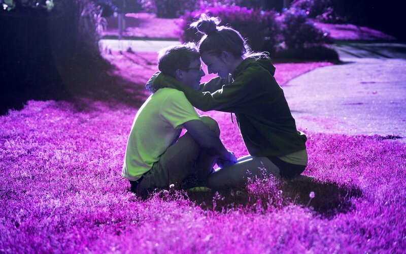 Couple Sitting on Grass — Purple