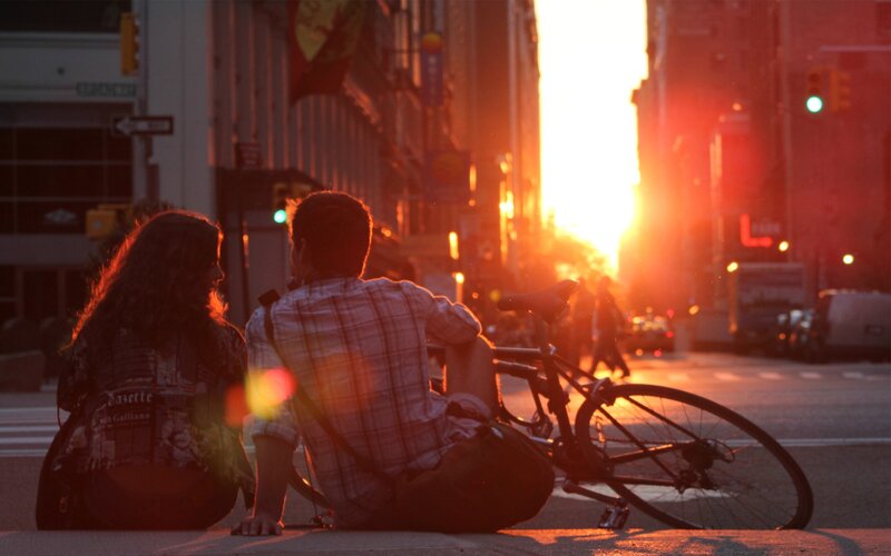 Couple Sitting on Sidewalk — Orange
