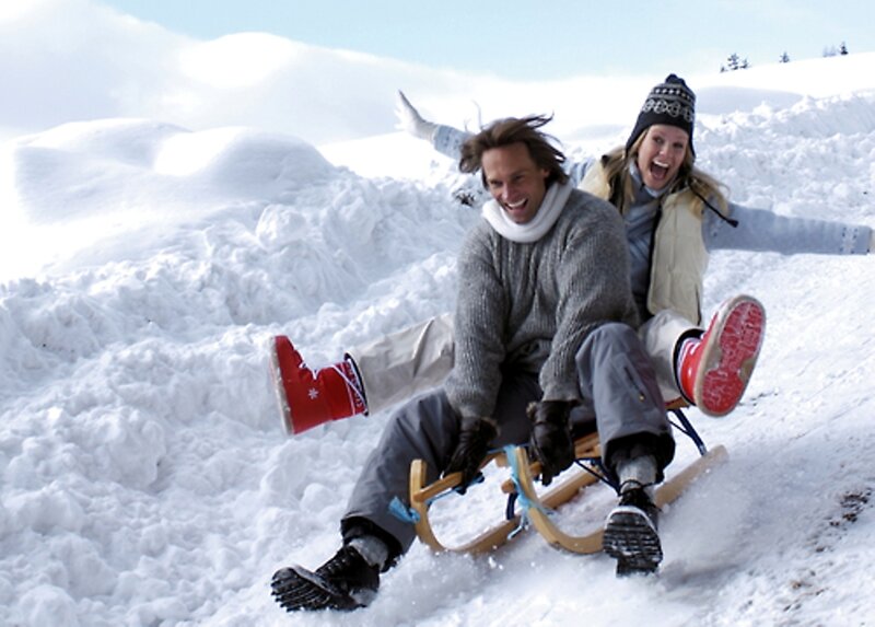 Couple Sledding in Snow — White
